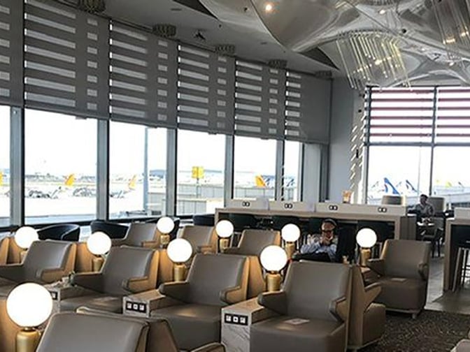 The seating area in Plaza Premium Lounge at Sabiha Gokcen International Airport features comfortable chairs with individual lighting and power outlets.
