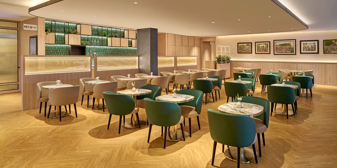 The dining area at Plaza Premium Lounge, Senai International Airport, features multiple tables with seating for travelers.