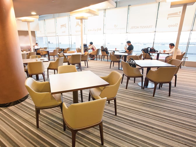 The MATINA Lounge East at Seoul Incheon Airport features a seating area with tables and chairs, offering views of the tarmac.