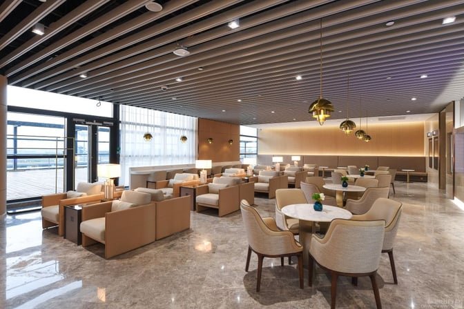 The No. 190 VIP Lounge at Shanghai Pudong International Airport features comfortable seating areas with tables and armchairs for travelers.