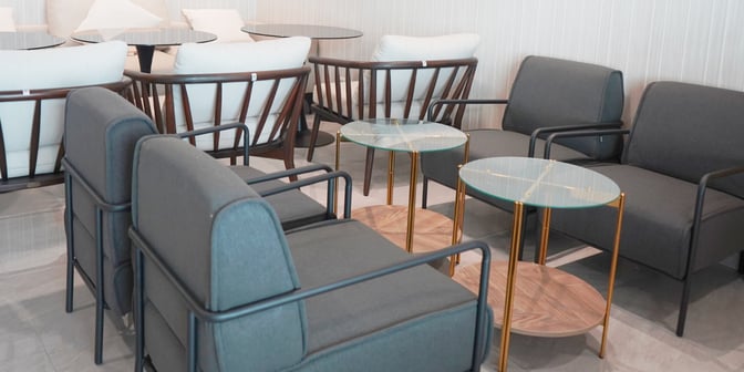 The seating area in Saphire Lounge at Sultan Thaha Airport features cushioned chairs and small tables for passenger comfort and relaxation.
