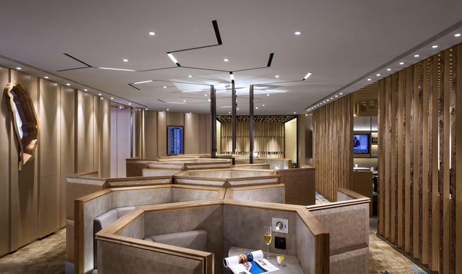 Booth seating in the Plaza Premium Lounge at Taiwan Taoyuan International Airport offers semi-private spaces with individual tables and power outlets.
