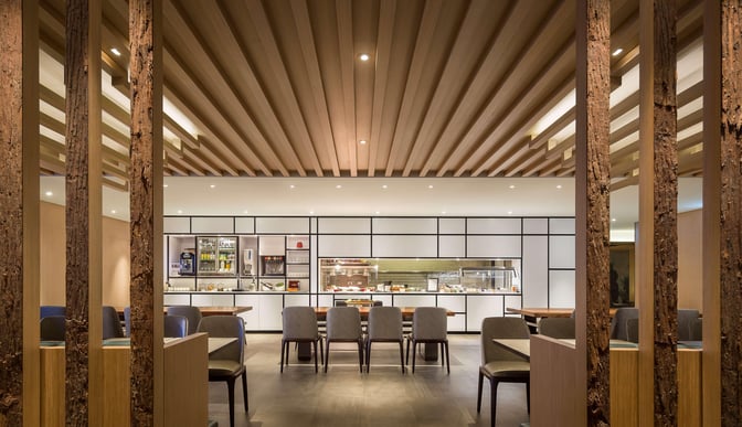 The dining area in Plaza Premium Lounge, Zone D at Taiwan Taoyuan International Airport, features self-serve food stations and ample seating.