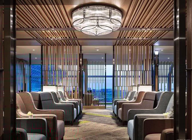 The seating area in Plaza Premium Lounge, Zone A at Taiwan Taoyuan International Airport, features rows of armchairs with privacy partitions.