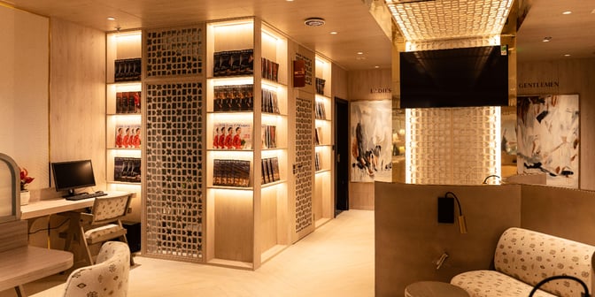 The SH Premium Lounge at Tan Son Nhat International Airport features a computer workstation and magazine display near the restrooms.