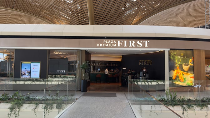 The entrance to Plaza Premium First at Techo International Airport features a reception area and visible bar seating inside.