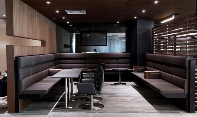 Semi-private booth seating in the Air France / KLM Lounge at Toronto Pearson offers tables and chairs for group or individual use.