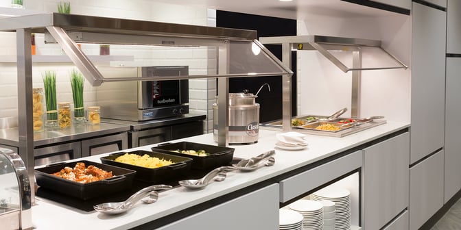 The self-serve food station at Plaza Premium Lounge, Toronto Pearson, offers a variety of hot dishes and snacks.