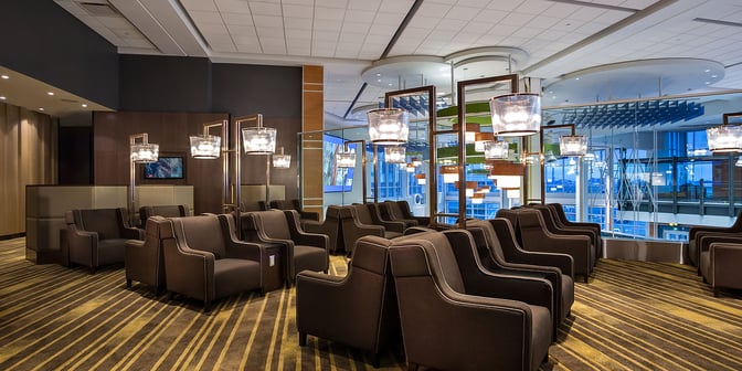The seating area in Plaza Premium Lounge at Vancouver International Airport offers comfortable armchairs with views of the terminal.