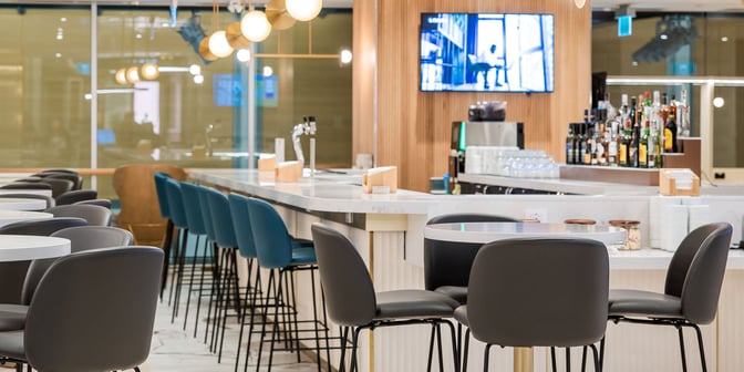 The Plaza Premium First lounge at Vancouver International Airport features a bar with a variety of spirits and ample seating.