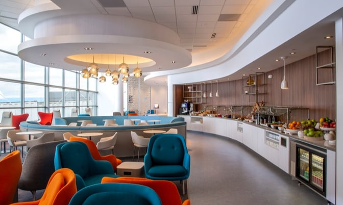 The Air France/KLM Lounge at Washington Dulles International Airport features a seating area with a self-serve food and beverage station.