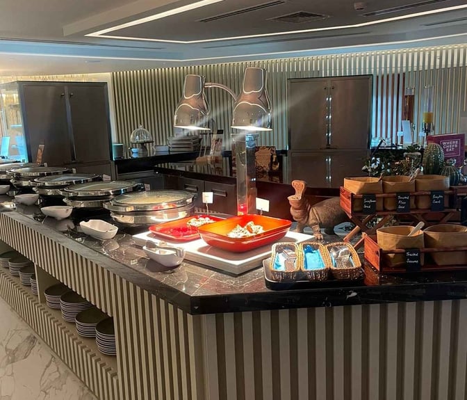 The buffet area at Pearl Lounge, Abu Dhabi International Airport, features a variety of hot dishes and a selection of seeds.