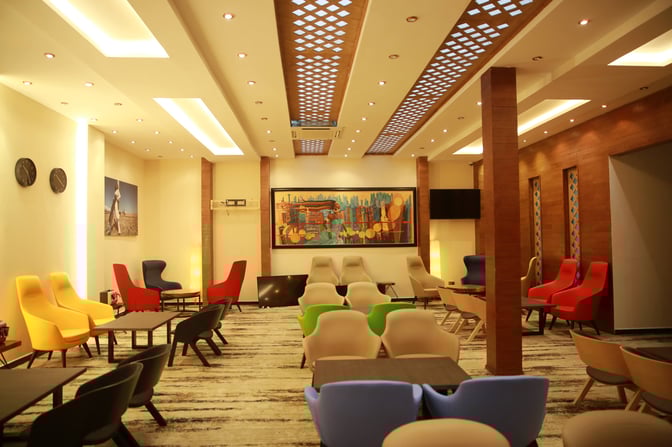 The seating area in the Plaza Premium Lounge at Addis Ababa Bole International Airport features various chairs and tables for relaxation.