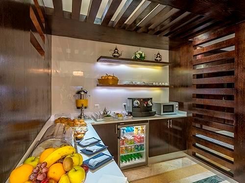 The Agadir Aspire Executive Lounge features a self-serve snack area with fresh fruit, beverages, and a coffee machine.