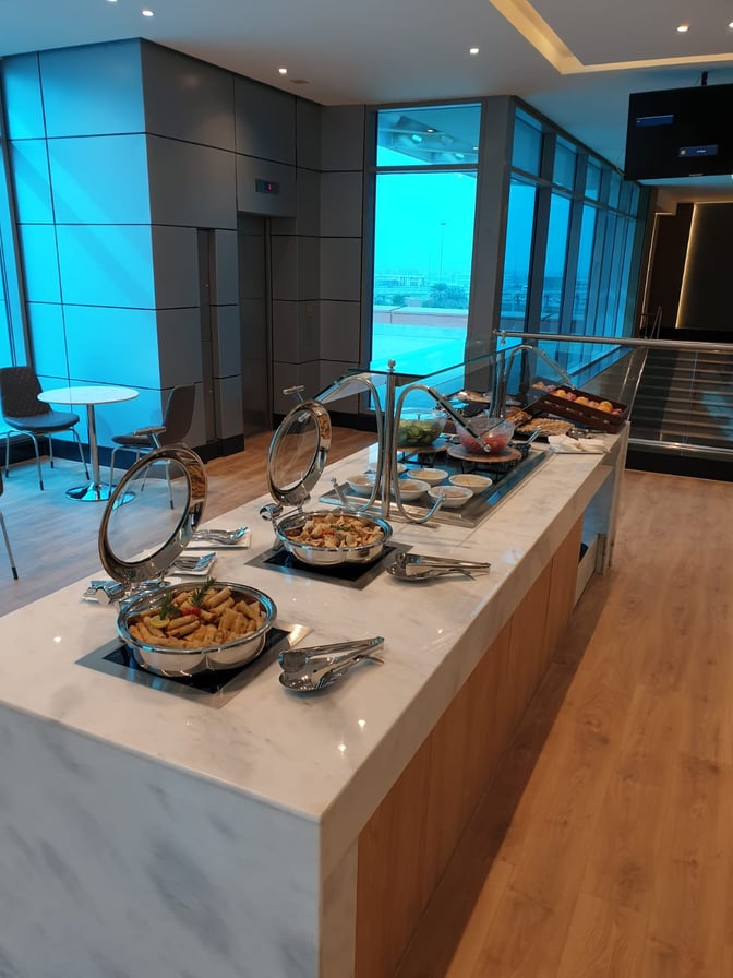 Self-serve food station in Ahlein Premium Lounge at Cairo International Airport offers a variety of hot dishes and pastries.
