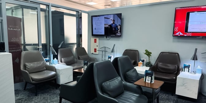 The seating area in Hayyak Lounge at Al-Jouf International Airport features comfortable chairs, small tables, and informational displays.