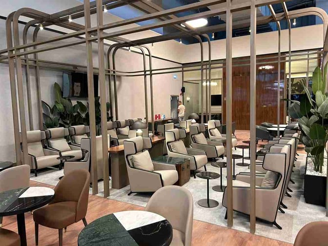 The seating area in the Extime Business Lounge at Almaty International Airport features comfortable chairs and tables for relaxation and work.