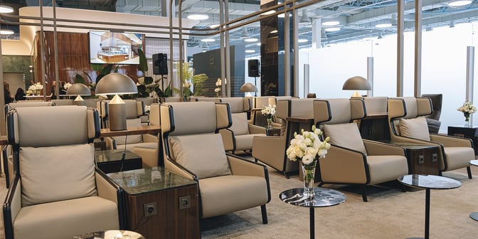 The seating area in the Extime Business Lounge at Almaty International Airport features comfortable armchairs with side tables and lamps.