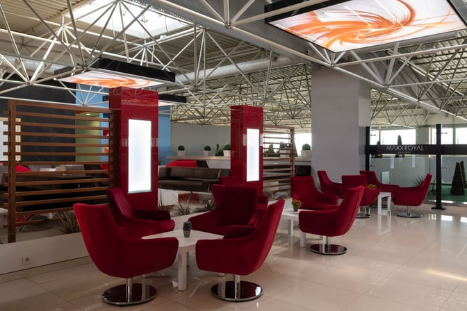 Seating area in the CIP Lounge at Antalya Airport features comfortable chairs and tables, providing a space for relaxation and conversation.