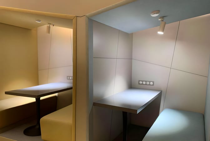 Booth seating at Primeclass Lounge in Ivato International Airport offers semi-private spaces with individual tables and power outlets.