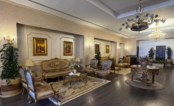 The Pearl Lounge at Aswan International Airport features a seating area with ornate furniture and decorative artwork on the walls.