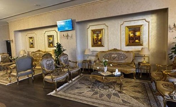 The seating area in the Pearl Lounge at Aswan International Airport features ornate chairs and sofas with decorative tables and framed artwork.