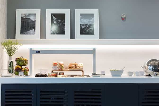 The Goldair Handling CIP Lounge at Athens Airport features a self-serve food station with fresh fruit, sandwiches, and salads.