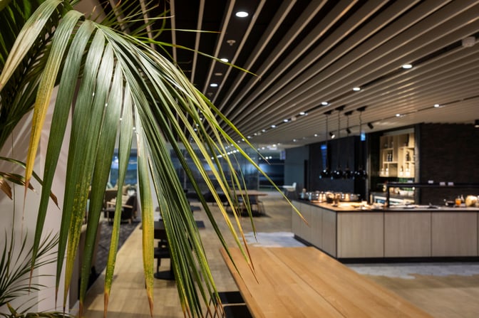 The Strata Lounge at Auckland Airport features a spacious dining area with self-serve food stations and ample seating options.