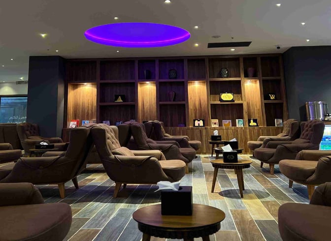 The seating area in the Iraqi Lounge at Baghdad International Airport features comfortable chairs and small tables with tissue boxes.