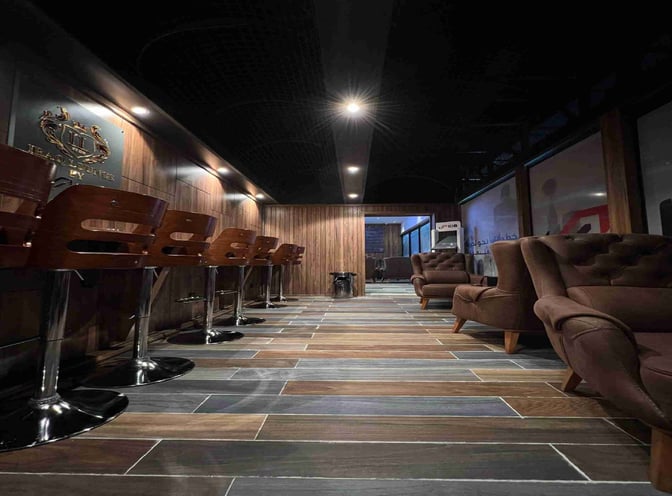 The Iraqi Lounge at Baghdad International Airport features bar seating with stools and a seating area with armchairs for relaxation.