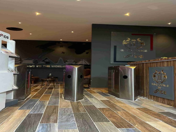 The entrance to the Iraqi Lounge at Baghdad International Airport features a reception desk and automated entry gates.
