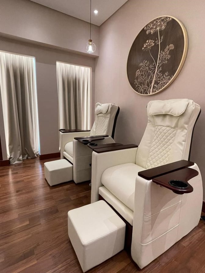Reclining chairs with footrests at Gulf Spa in Bahrain International Airport offer comfortable seating for relaxation and spa services.