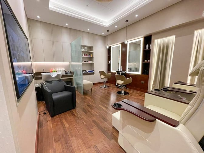 The Gulf Spa at Bahrain International Airport features salon chairs, a hair washing station, and mirrors for personal grooming services.