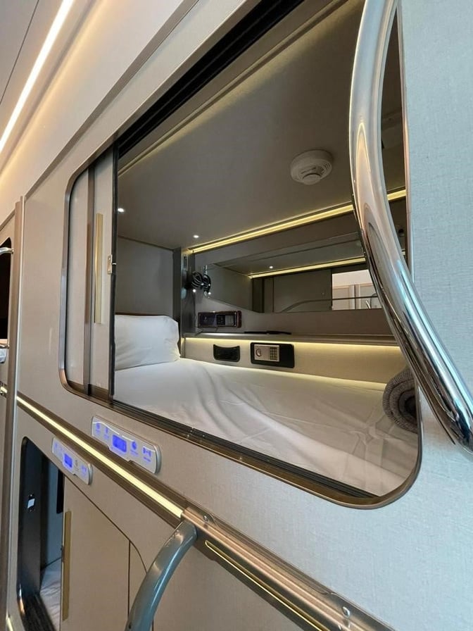 Sleeping pods at Gulf Spa, Bahrain International Airport, feature individual beds with control panels and personal lighting for passenger comfort.