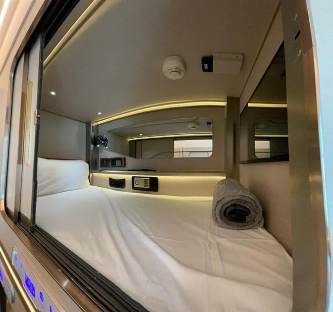 Sleeping pods at Gulf Spa, Bahrain International Airport, offer a private resting space with a bed, safe, and control panel.