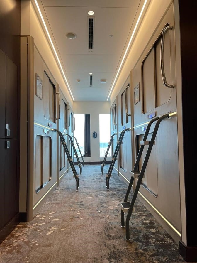 Sleeping pods at Gulf Spa, Bahrain International Airport, feature individual compartments with ladders for travelers to rest between flights.