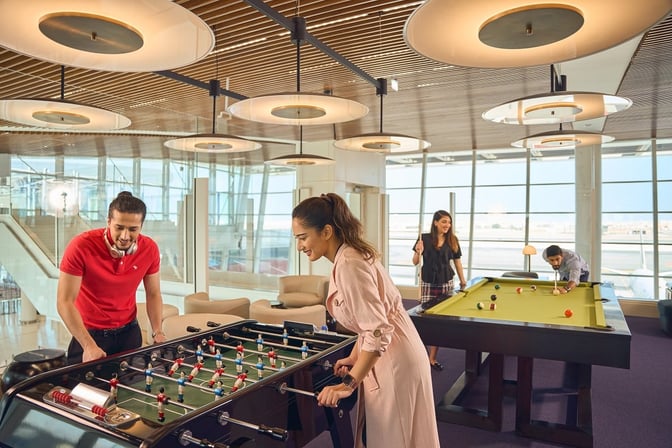 The Pearl Lounge at Bahrain International Airport features a recreational area with foosball and pool tables for passenger entertainment.
