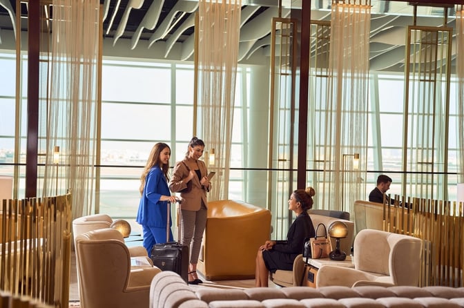 Seating area in The Pearl Lounge at Bahrain International Airport features comfortable chairs and tables, providing a relaxed environment for travelers.