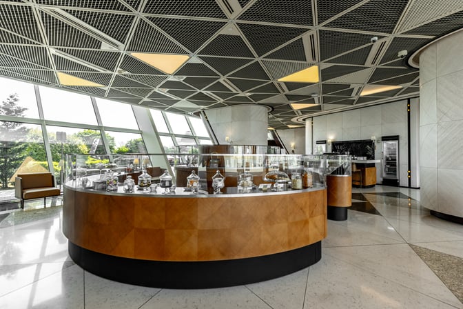 The Salam Lounge at Heydar Aliyev International Airport features a self-serve snack station with various treats in glass jars.