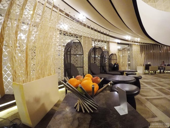 The Absheron Lounge at Heydar Aliyev International Airport features seating with tables and decorative elements, providing a relaxing space for travelers.