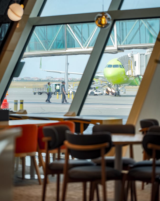 Seating in the Premium Bank Lounge at Heydar Aliyev International Airport offers views of the tarmac and boarding gates.