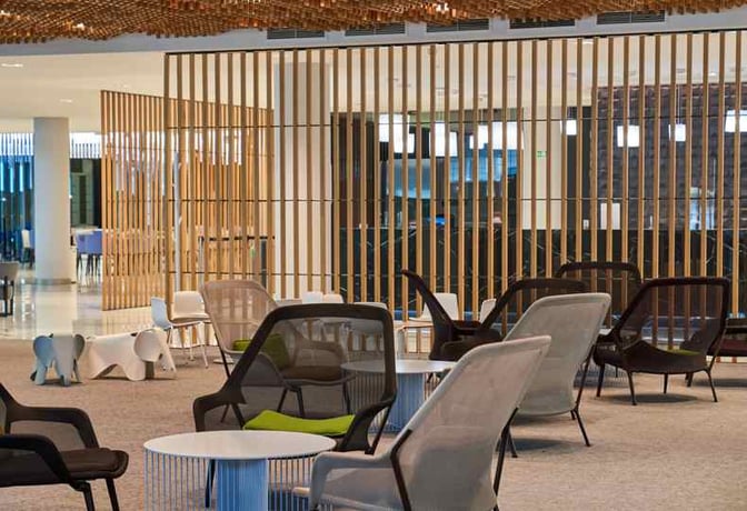 The seating area in Sala VIP Miró at Barcelona Airport features comfortable chairs and tables, providing a relaxing space for travelers.