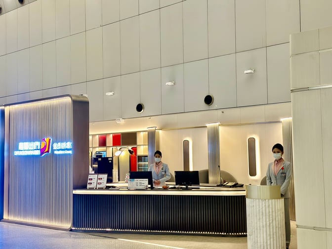 The entrance to the Beijing Capital V6 Lounge features a reception desk staffed by attendants, located at Beijing Capital International Airport.