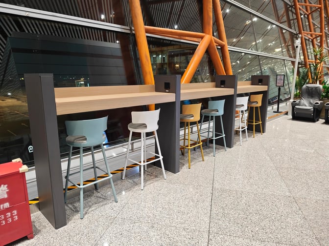 High-top seating at the CIP International Lounge in Beijing Capital Airport offers counter space with views of the tarmac.