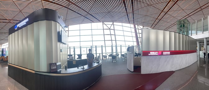The entrance to the Airport Club A3 Members Lounge at Beijing Capital International Airport features a reception desk and seating area.
