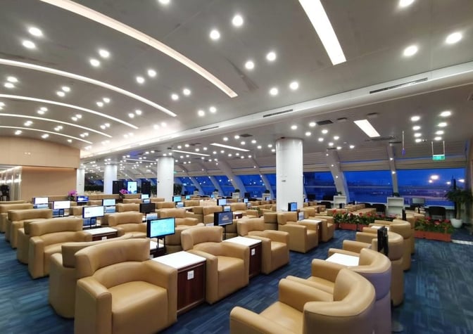 The China Eastern Lounge at Beijing Capital International Airport features spacious seating with individual screens and views of the airport runway.