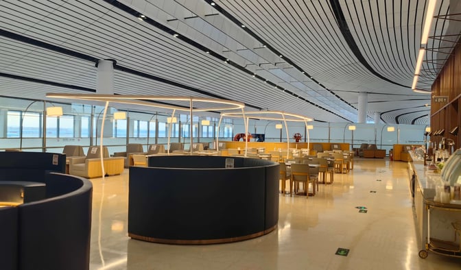 The China Southern First/Business Class Lounge at Beijing Daxing International Airport features spacious seating areas and a self-serve dining section.