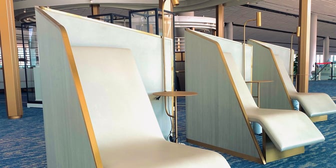 Semi-private seating pods in the CHUM International Lounge at Beijing Daxing Airport offer individual reclined seats with integrated side tables.