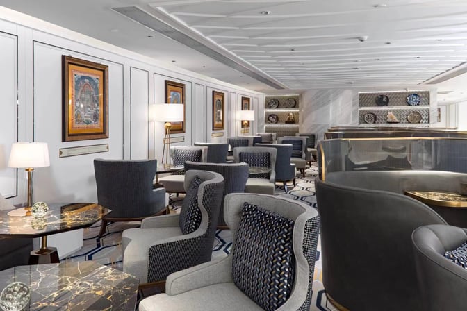 The seating area in Dong Hai Passenger Lounge at Beijing Daxing International Airport features comfortable chairs and tables for relaxation.