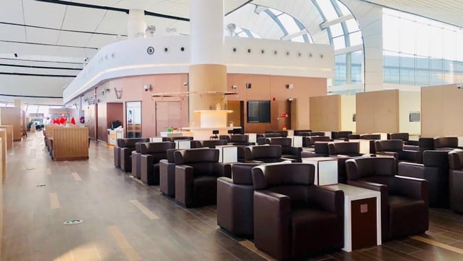 The seating area in the V3 China Eastern Lounge at Beijing Daxing International Airport features numerous armchairs with individual tables.